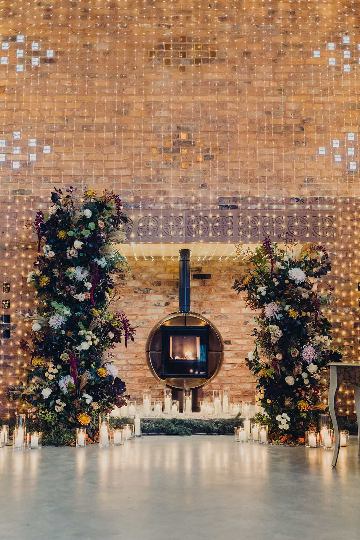 Two tall flower towers in a wedding ceremony room