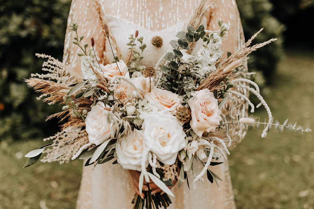 A bride holding a large intricate bouquet